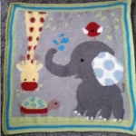 crochet baby blanket with giraffe, turtle, elephant and bird motif